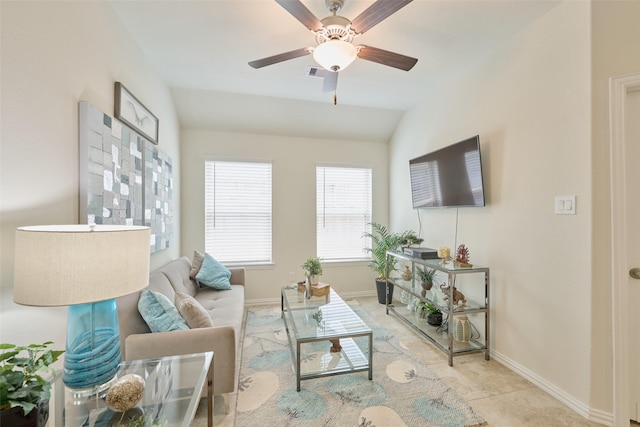 living area featuring baseboards, vaulted ceiling, and ceiling fan