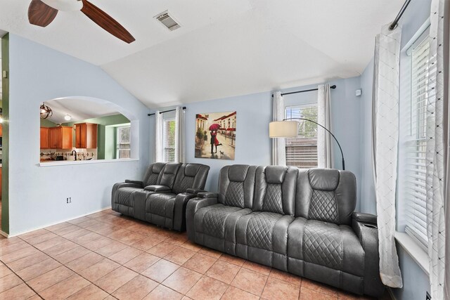 living room featuring a ceiling fan, baseboards, light tile patterned floors, lofted ceiling, and visible vents