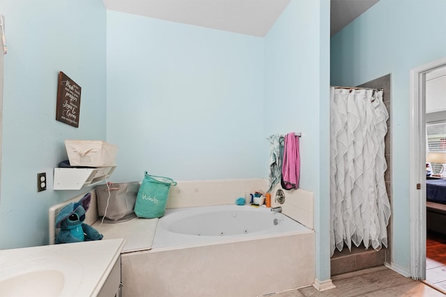 9815 Hallmark Ln, Pearland, TX 77584 - full bathroom featuring wood finished floors, a tub with jets, vanity, and a shower with curtain