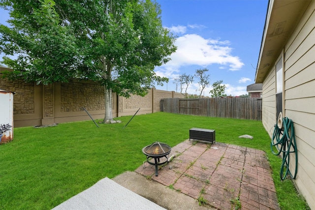 9815 Hallmark Ln, Pearland, TX 77584 - view of yard featuring an outdoor fire pit and a patio