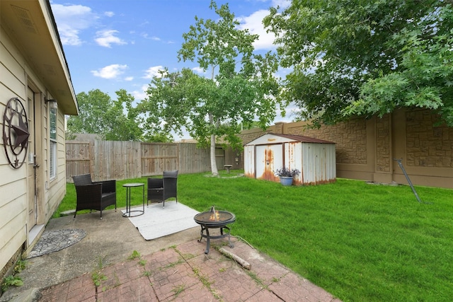 9815 Hallmark Ln, Pearland, TX 77584 - view of yard featuring a fire pit, a shed, a patio area, and an outdoor structure