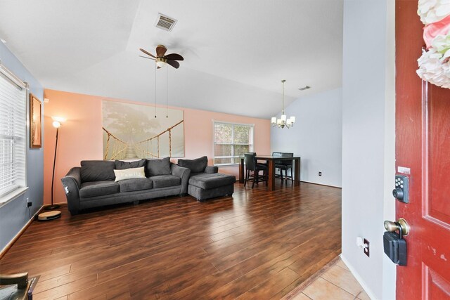 living room with visible vents, ceiling fan with notable chandelier, lofted ceiling, and hardwood / wood-style floors