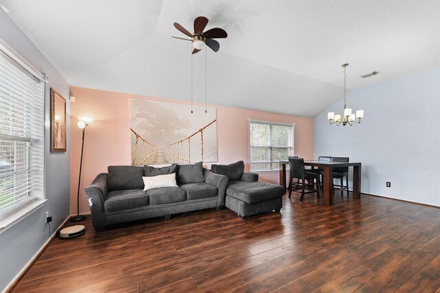 living area featuring visible vents, ceiling fan with notable chandelier, wood finished floors, and vaulted ceiling
