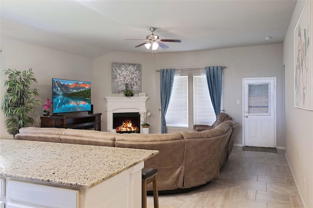 2757 Maxway Ct, League City, TX 77573 - living room with ceiling fan, a lit fireplace, and baseboards