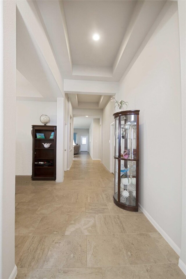 2757 Maxway Ct, League City, TX 77573 - corridor with baseboards, stone finish flooring, and a tray ceiling