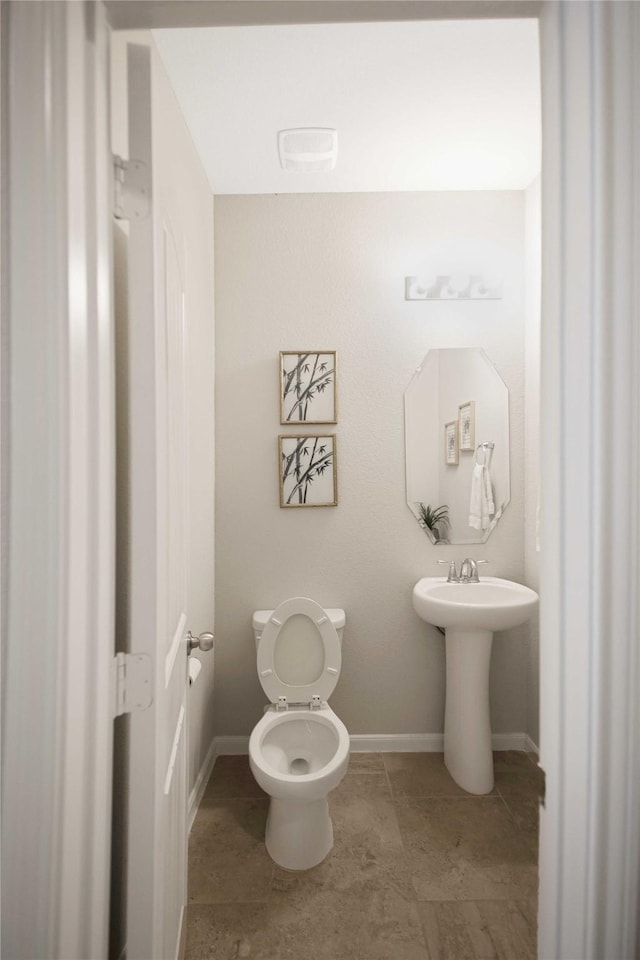 2757 Maxway Ct, League City, TX 77573 - half bathroom with baseboards, toilet, and a sink