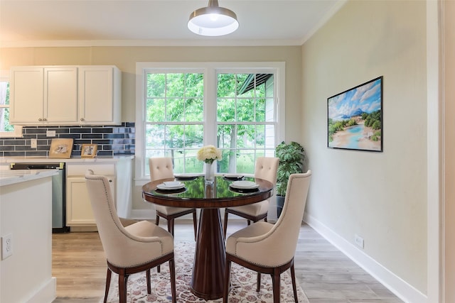 208 W Jefferson St, Trinity, TX 75862 - dining area featuring healthy amount of natural light, ornamental molding, light wood-style floors, and baseboards