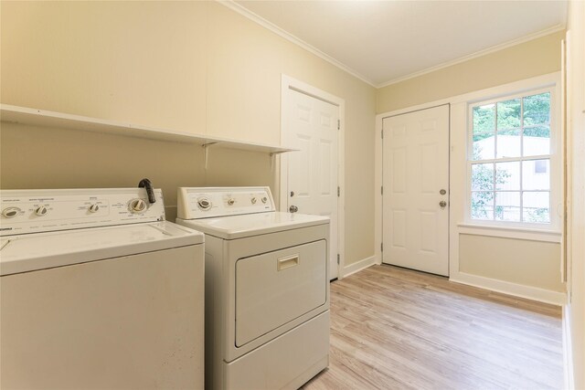 208 W Jefferson St, Trinity, TX 75862 - washroom with separate washer and dryer, crown molding, light wood-style floors, and baseboards