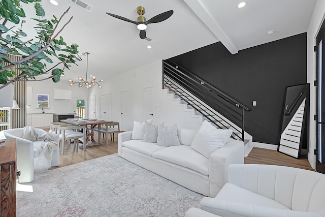 6726 Dumble St, Houston, TX 77021 - living area with stairs, wood finished floors, ceiling fan, a chandelier, and recessed lighting