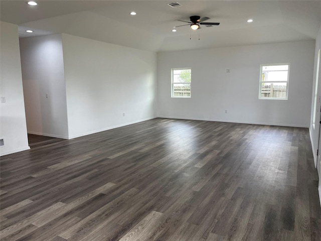 empty room featuring a ceiling fan, baseboards, dark wood-style flooring, visible vents, and recessed lighting
