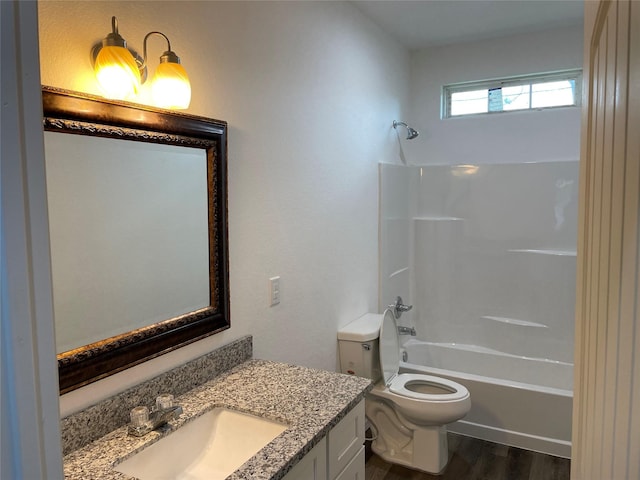 full bathroom with toilet, vanity, wood finished floors, and tub / shower combination