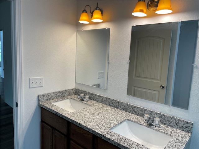 bathroom featuring a sink and double vanity