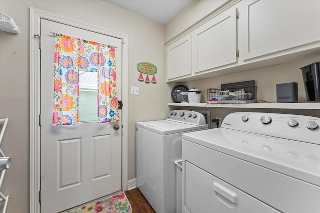 laundry area with washer and clothes dryer, cabinet space, and dark wood-style flooring