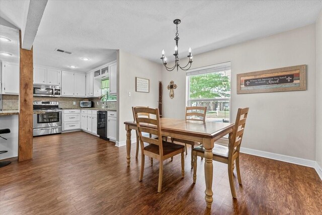 dining room featuring baseboards, visible vents, dark wood finished floors, and a notable chandelier