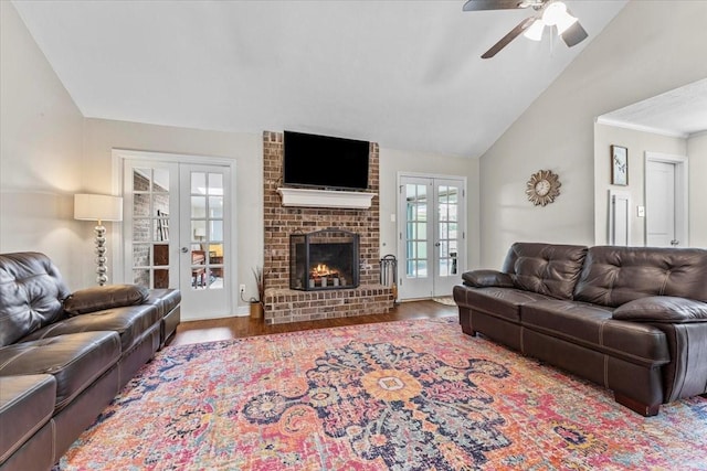 living area featuring french doors, ceiling fan, lofted ceiling, and wood finished floors