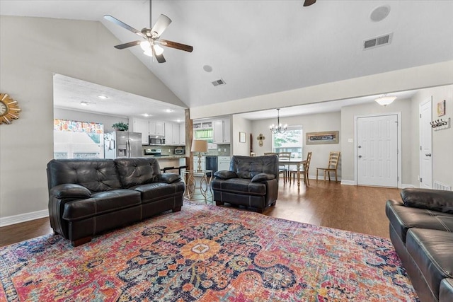living room featuring visible vents, ceiling fan with notable chandelier, wood finished floors, and high vaulted ceiling