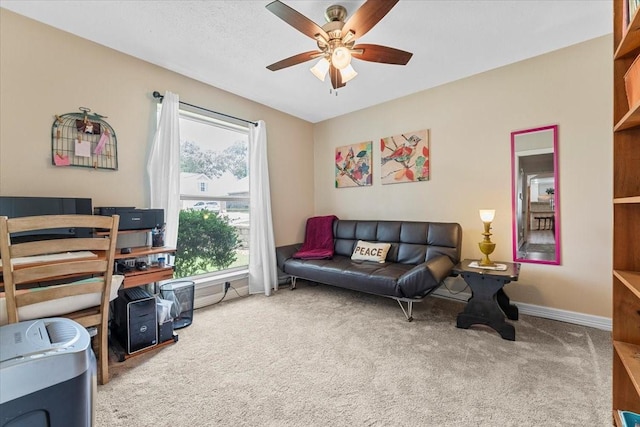living area with carpet floors, a ceiling fan, and baseboards