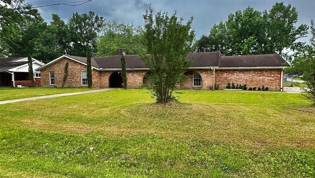 200 Greenwood Dr, Beaumont, TX 77705 - ranch-style home featuring driveway, brick siding, and a front yard