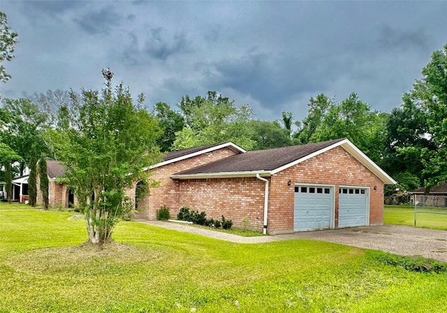 200 Greenwood Dr, Beaumont, TX 77705 - view of front facade with a front lawn, fence, a garage, brick siding, and aphalt driveway