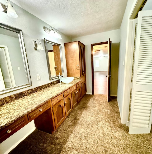 200 Greenwood Dr, Beaumont, TX 77705 - bathroom featuring carpet floors, vanity, and a textured ceiling