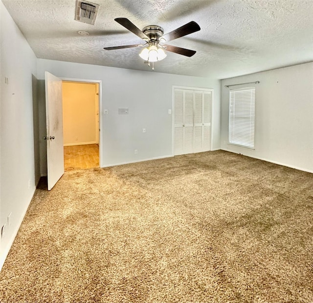 200 Greenwood Dr, Beaumont, TX 77705 - carpeted empty room featuring baseboards, visible vents, a textured ceiling, and ceiling fan