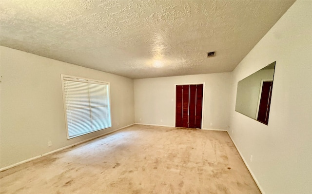 200 Greenwood Dr, Beaumont, TX 77705 - unfurnished room featuring visible vents, baseboards, carpet flooring, and a textured ceiling