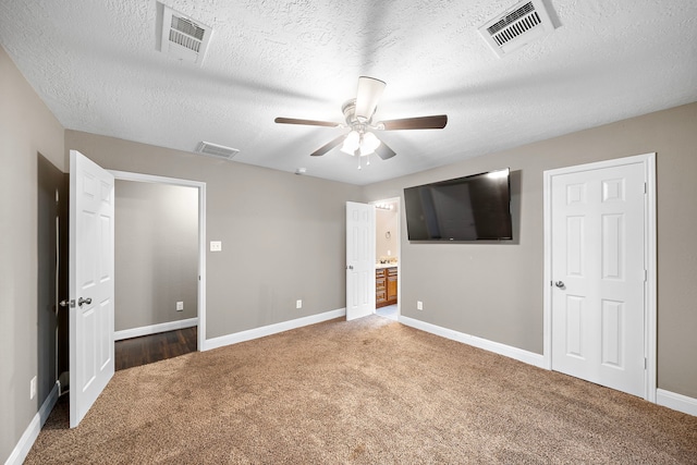 1111 Robert St, Pearland, TX 77581 - unfurnished bedroom with carpet flooring, baseboards, a textured ceiling, ensuite bath, and a ceiling fan