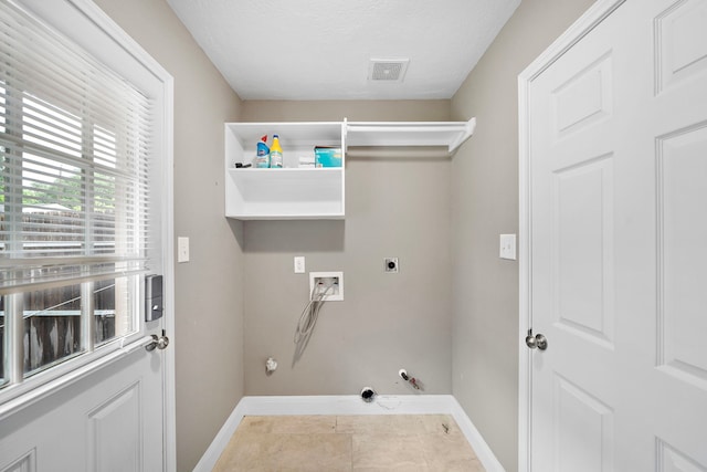 1111 Robert St, Pearland, TX 77581 - clothes washing area featuring hookup for a gas dryer, washer hookup, baseboards, hookup for an electric dryer, and a textured ceiling
