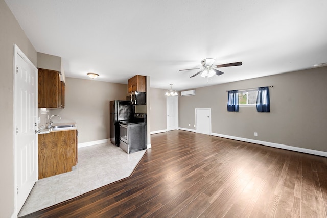 1111 Robert St, Pearland, TX 77581 - kitchen with appliances with stainless steel finishes, a ceiling fan, brown cabinetry, open floor plan, and a sink