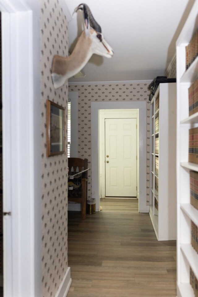 interior space with light wood-style floors and wallpapered walls