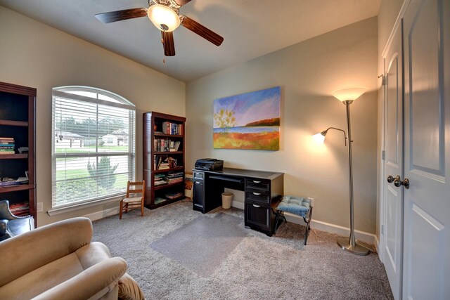 carpeted home office with a ceiling fan and baseboards