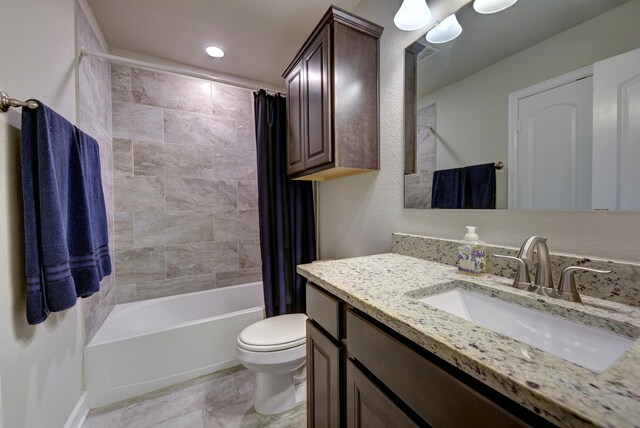 bathroom with vanity, toilet, and shower / bath combo