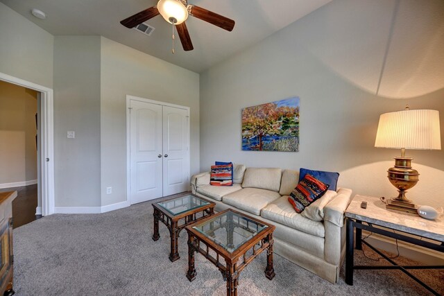 living area with baseboards, a ceiling fan, visible vents, and carpet