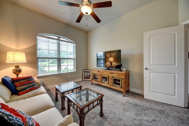 carpeted living room featuring a ceiling fan and baseboards