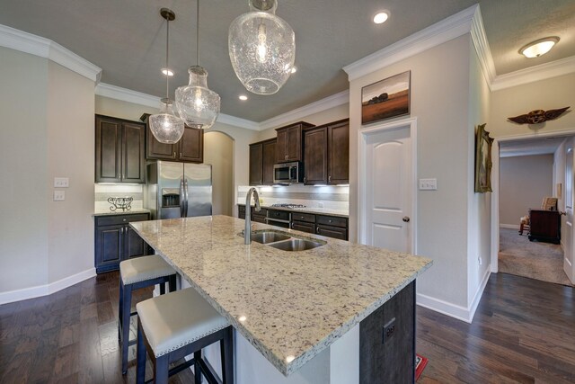 kitchen with a sink, dark brown cabinetry, stainless steel appliances, baseboards, and dark wood-style flooring