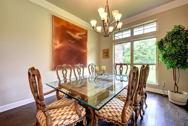 dining room with wood finished floors, an inviting chandelier, and ornamental molding