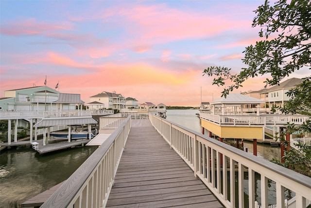dock area featuring a water view and a residential view