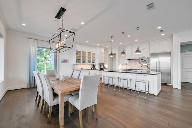 dining space featuring recessed lighting, visible vents, an inviting chandelier, and dark wood-type flooring