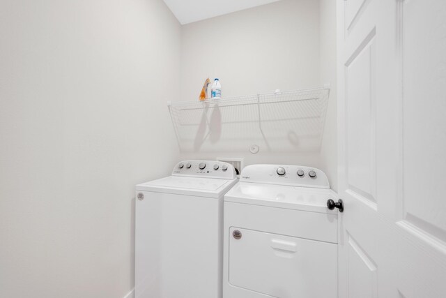 washroom featuring washing machine and dryer and laundry area