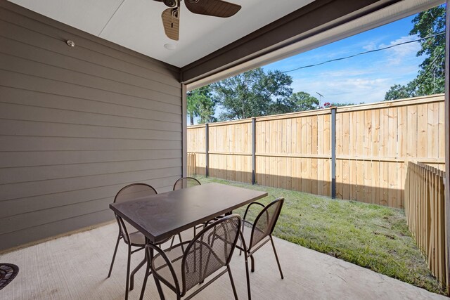 view of patio / terrace featuring a fenced backyard, outdoor dining space, and ceiling fan