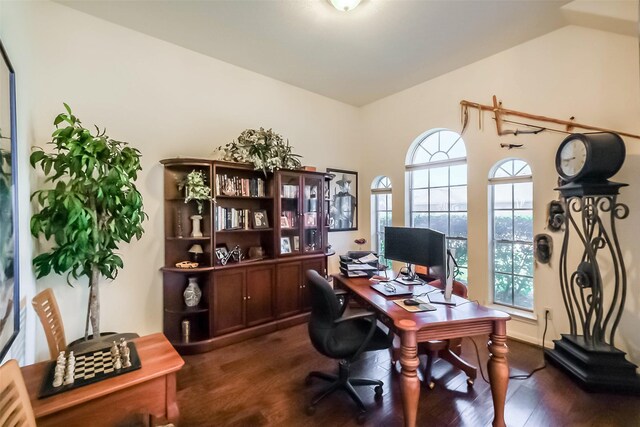 office with vaulted ceiling and dark wood-style flooring