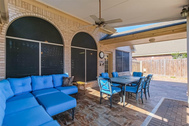 view of patio / terrace with outdoor dining area, fence, a ceiling fan, and an outdoor hangout area