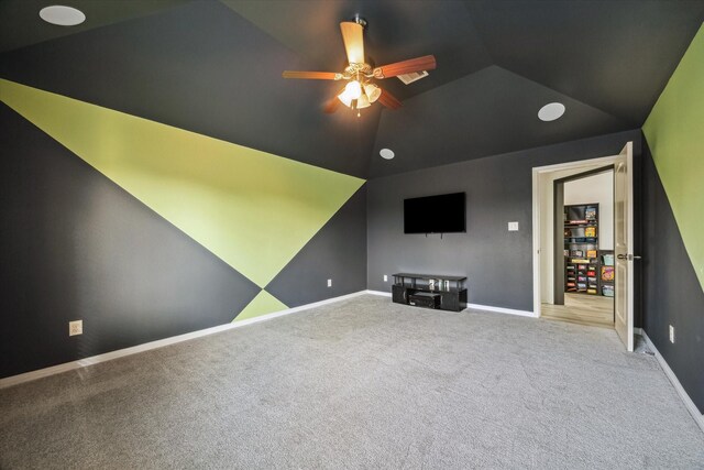 living room featuring carpet floors, baseboards, a ceiling fan, and vaulted ceiling