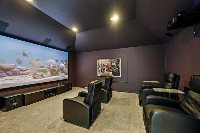 carpeted cinema featuring lofted ceiling