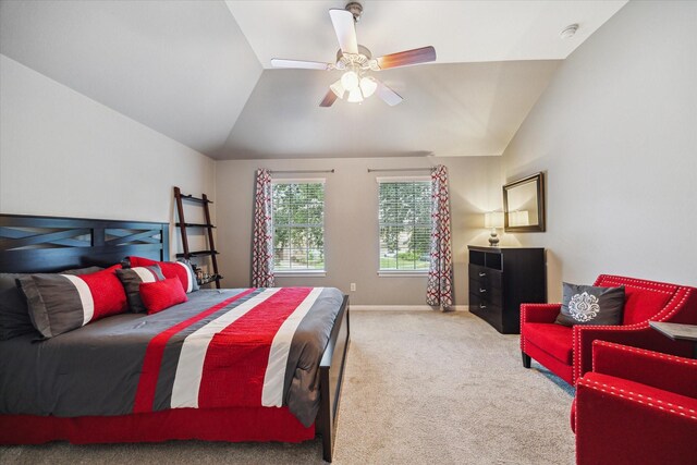 carpeted bedroom with baseboards, a ceiling fan, and vaulted ceiling