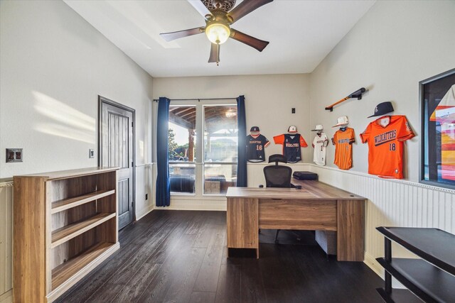 office area with ceiling fan, a wainscoted wall, and dark wood-style floors