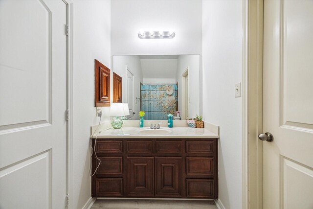 bathroom with vanity and baseboards