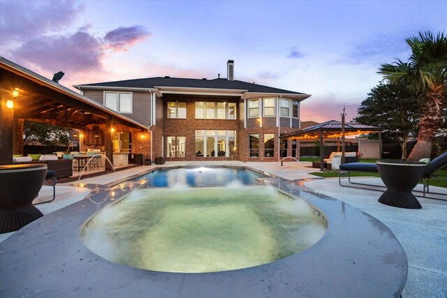 outdoor pool featuring a gazebo, outdoor lounge area, a patio area, and a jacuzzi