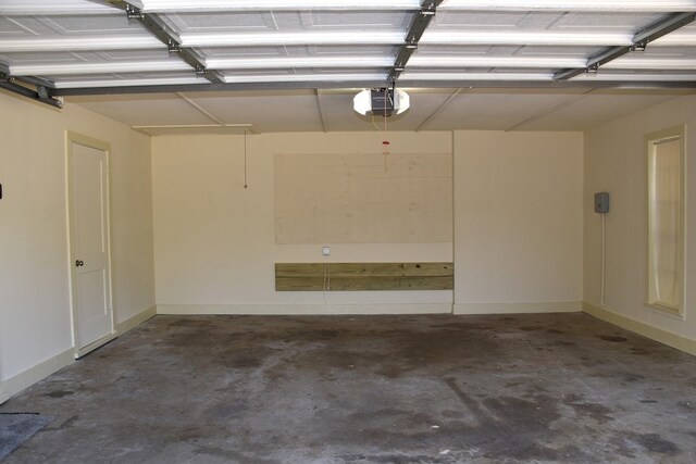 garage with a garage door opener and baseboards