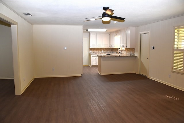 kitchen with white cabinets, dark wood-style floors, visible vents, a sink, and ceiling fan